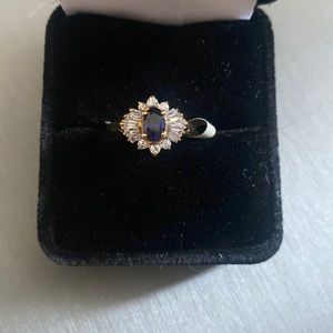 Sapphire center with round diamonds and baguettes .